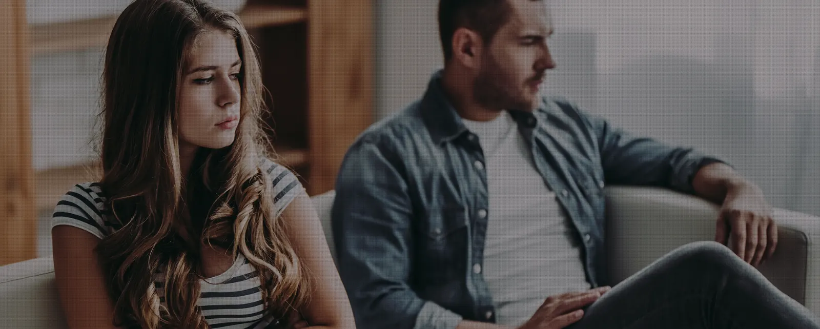 Couple sitting apart on a sofa during a divorce